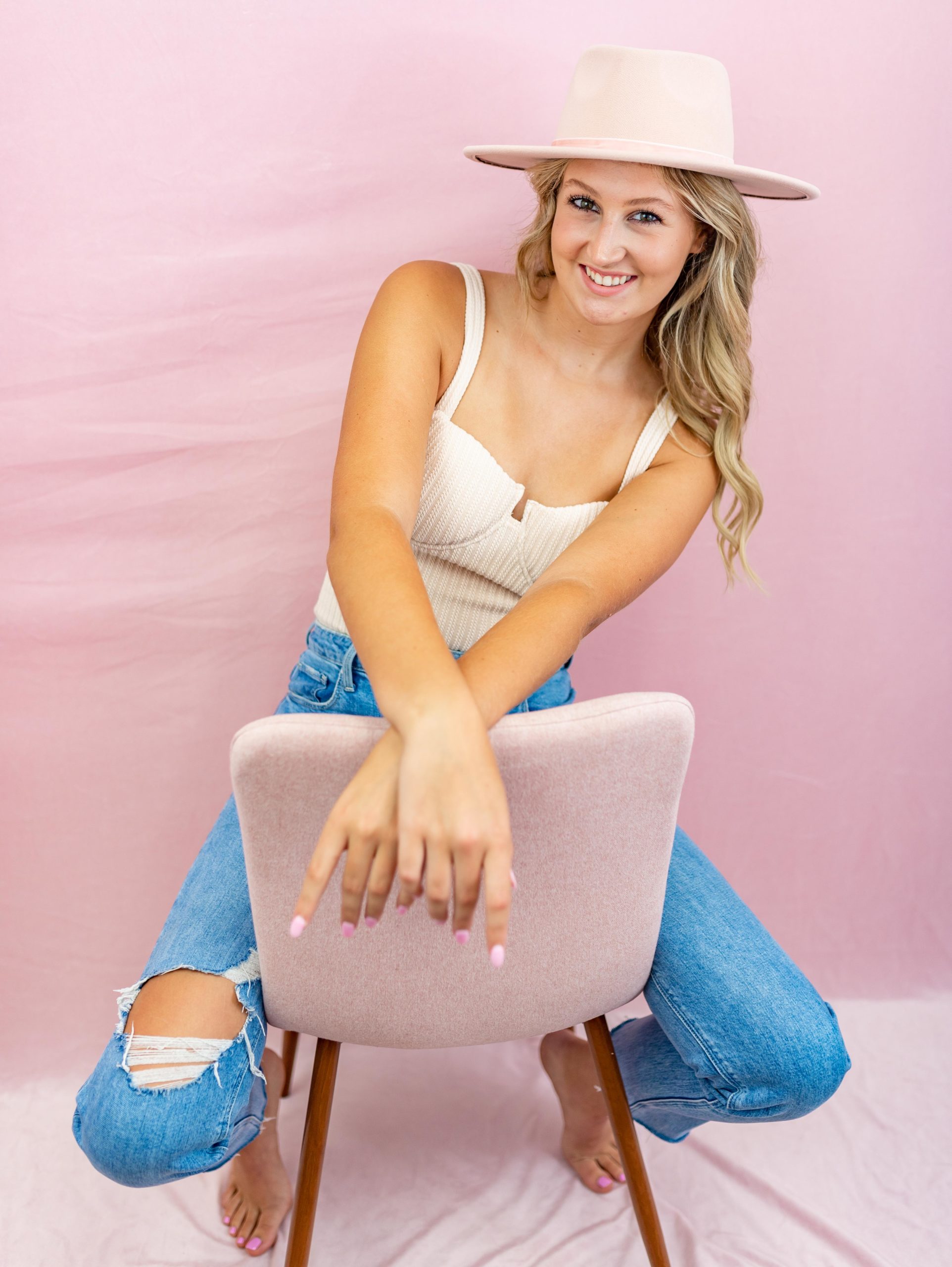 girl wearing hat sitting in a chair